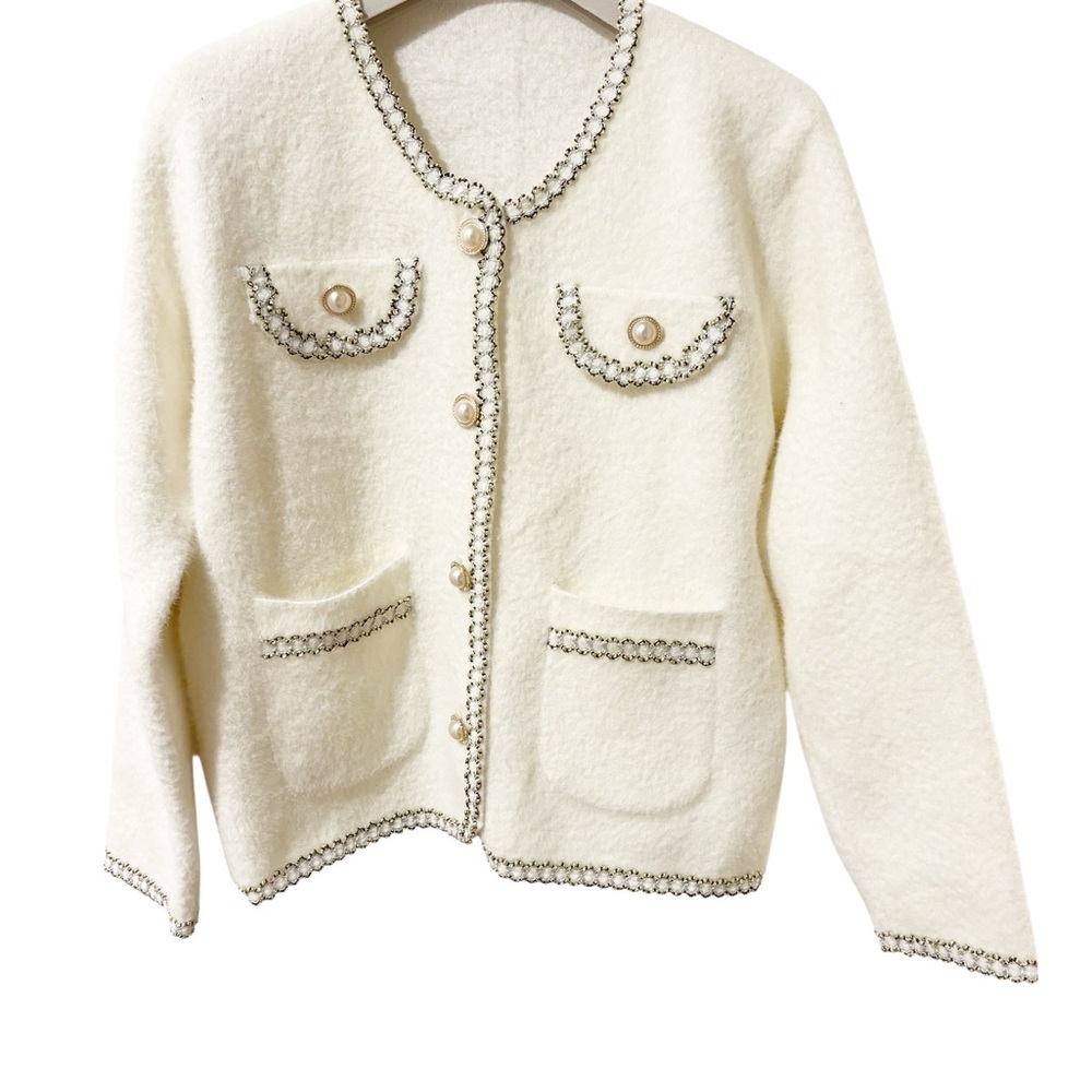 Creamy jacket with gold trims and pearl buttons